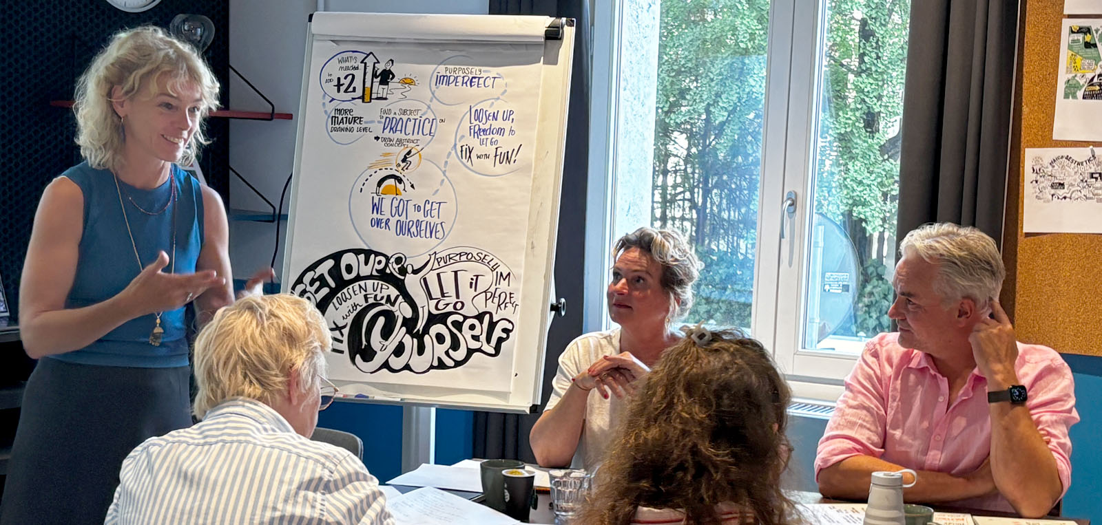 A photo of Axelle Vanquallie training some of the retreat attendees in a visual storytelling session